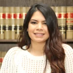 NotebookLM.in for AILET 2025: A young woman sitting confidently in front of legal books, representing focused and organised preparation for AILET aspirants.