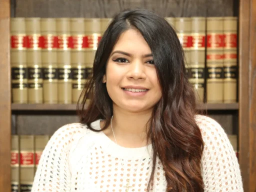 NotebookLM.in for AILET 2025: A young woman sitting confidently in front of legal books, representing focused and organised preparation for AILET aspirants.