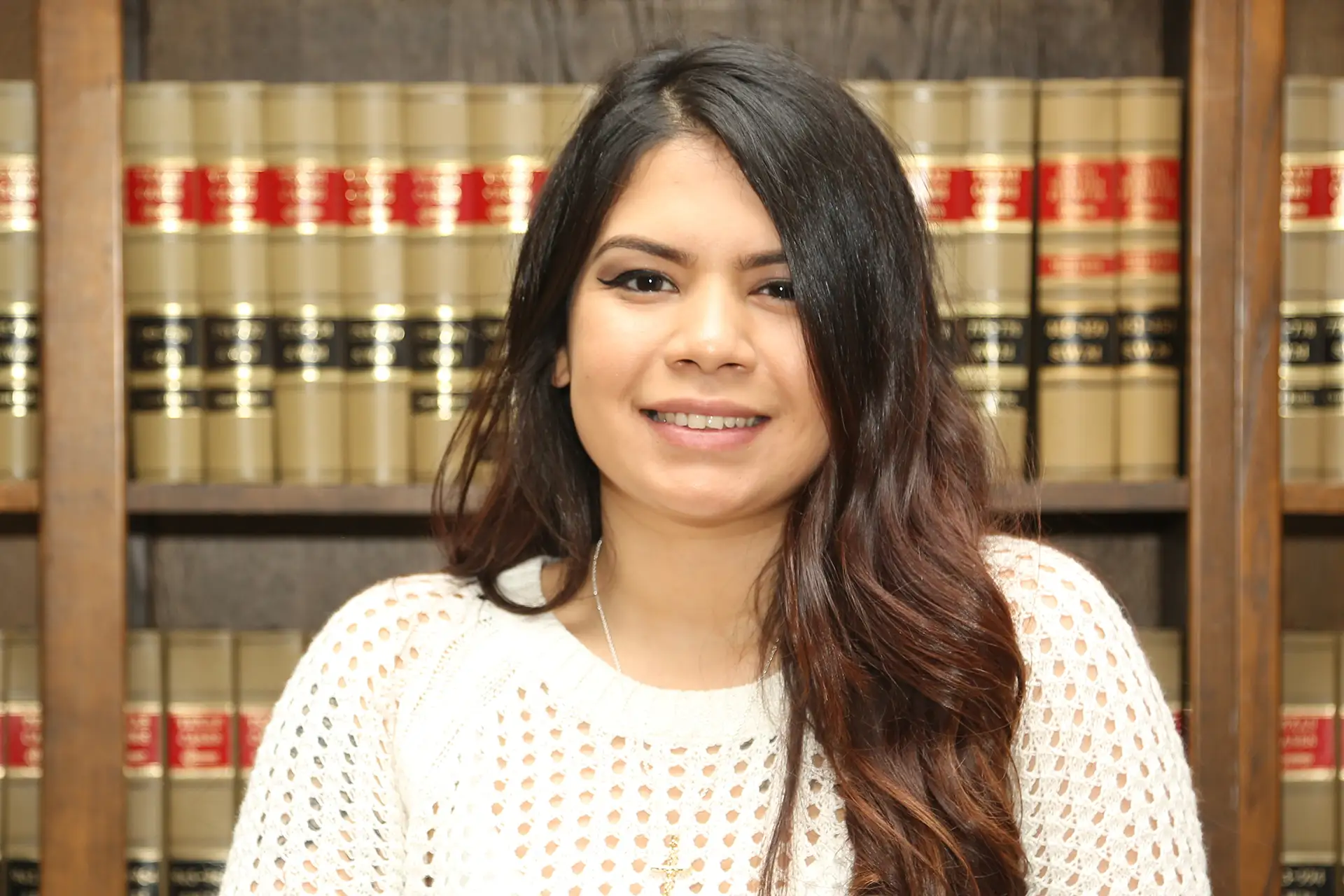 NotebookLM.in for AILET 2025: A young woman sitting confidently in front of legal books, representing focused and organised preparation for AILET aspirants.